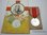 Medalla de la Cruz Roja y postal