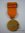 Miniatura de la medalla de sufrimientos por la Patria, cinta naranja