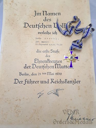 Mothers cross in gold with award document
